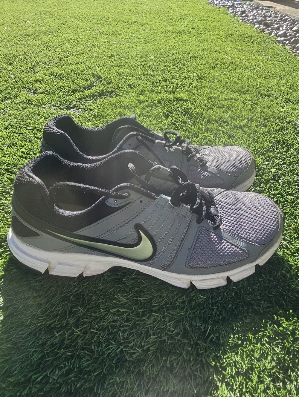 grey Nike Downshifter 5 MSL running shoes featuring a distinctive green Logo